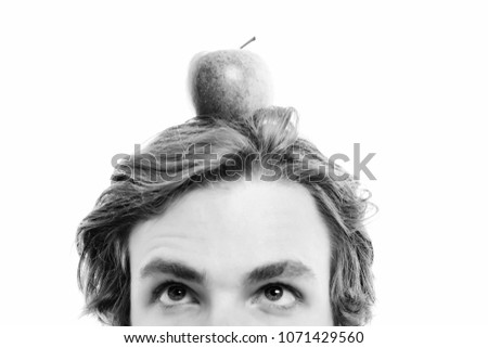 Apple on head. Small red and yellow apple fruit in young caucasian mans hair, isolated on white background. Idea of vegetarian food
