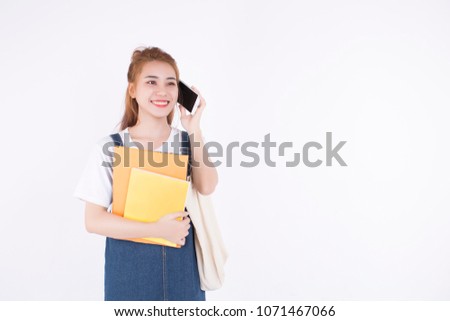 Asian female student with notebooks and bag