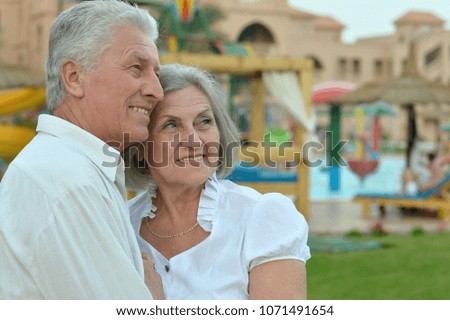  Senior couple at  hotel resort hugging