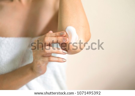 Woman applying elbow cream/lotion, Hygiene skin body care concept.
 Royalty-Free Stock Photo #1071495392