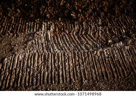 Tyre track on dirt sand or mud, Picture in retro or grunge tone. Car drive on sand. off road track.
