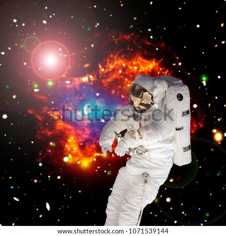 Astronaut flying and deep space on the backdrop. The elements of this image furnished by NASA.