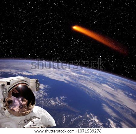 Comet flyin above earth and astronaut watching. The elements of this image furnished by NASA.