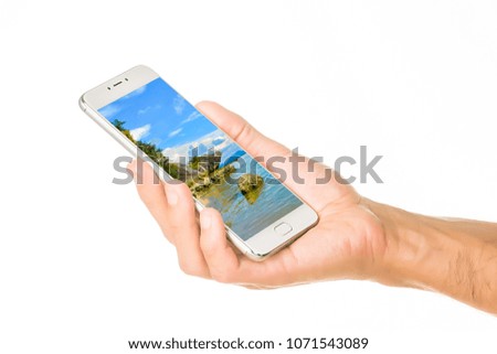 New smartphone with a colorful screensaver holds with a male hands palm isolated on white background. Modern technology.
