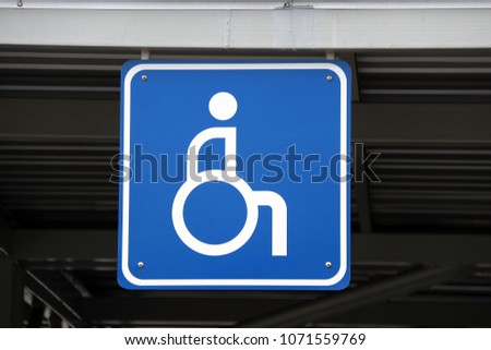 Blue and white sign mark of car parking for the disabled. Disabled's parking spaces usually near exits to increase the comfortable for them and to facilitate the act of parking.