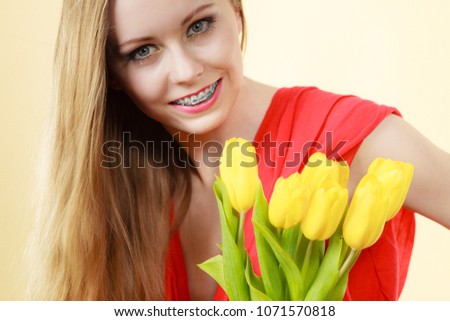 International womens day, eight march. Beautiful young woman with yellow tulips. Mothers day. On bright