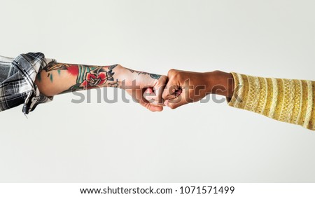 People bumping their fists together Royalty-Free Stock Photo #1071571499