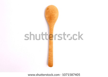 Wooden spoon against white backdrop.