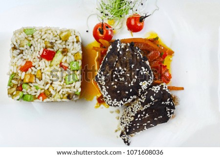 Closeup picture on dish of beef medallion served with rice and vegetables.
Prime Veal with Risotto.