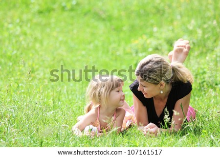 young mother and her little daughter on the nature