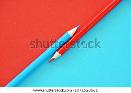 Two colored pencils split a picture in half in two different colors Royalty-Free Stock Photo #1071628661