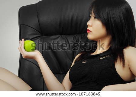 beautiful asian woman with apple sitting in business chair