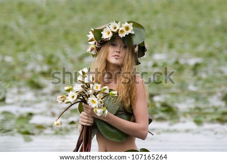 A girl in a lake with water lilies