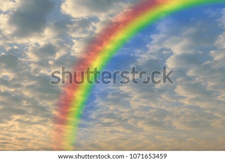 Cloudscape rainbow of natural sky with red sky and white clouds and colorful rainbow in the sky use for wallpaper background