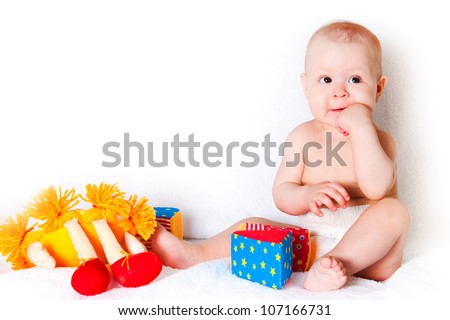 The sitting kid with toys on a white background