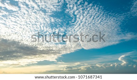 Blue Sky Background with White Clouds. Altocumulus Cloud During Sunrise. Royalty-Free Stock Photo #1071687341