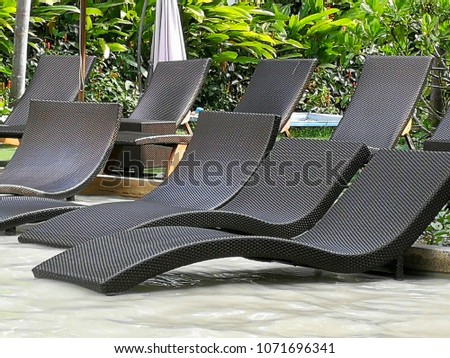 Black beach chair at the swimming pool.