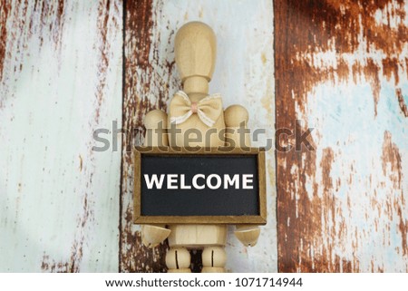Dummy holding WELCOME sign