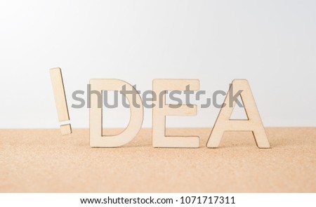 Business and design concept - wooden word " idea " with exclamation mark on wooden desktop and white background 