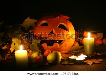 Halloween pumpkin head jack lantern with burning candles.