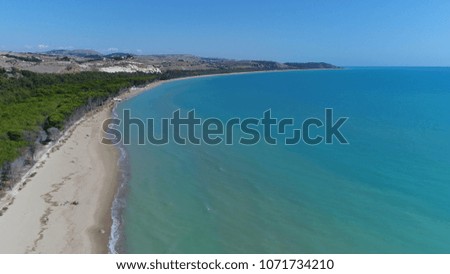 Aerial bird view photo of tropical beach showing the white beach on left side and azure blue sea on right side beautiful summer vacation photo