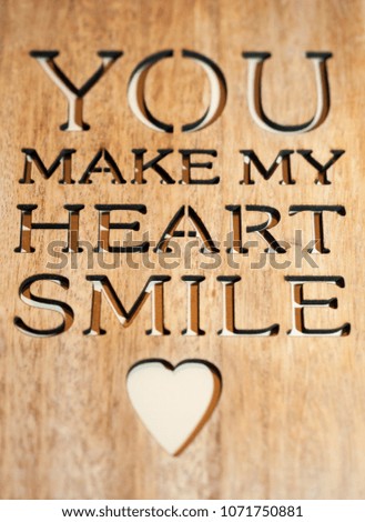 Cut out phrase and heart on wooden surface