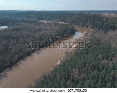 drone image. aerial view of forest river with sandstone cliffs in spring. Gauja, Latvia, sunny day - vintage film look