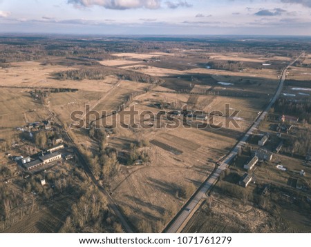 drone image. aerial view of rural area with houses and road network. populated area Dubulti near Jekabpils, Latvia. spring day, clear fields - vintage look