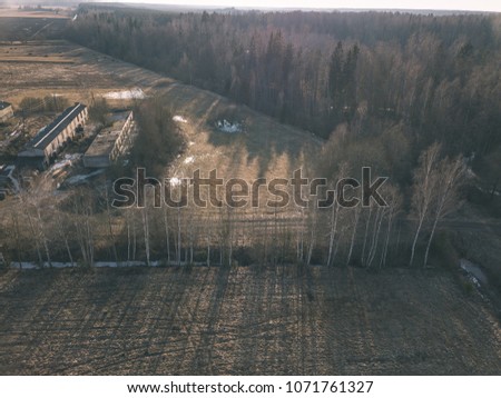 drone image. aerial view of rural area with houses and road network. populated area Dubulti near Jekabpils, Latvia. spring day, clear fields - vintage look