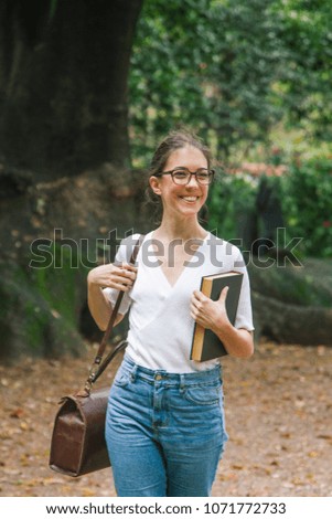 friendly female student with academic books at university