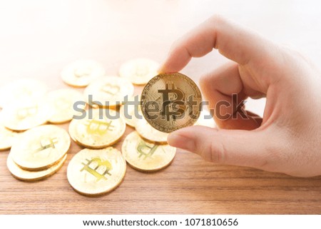 Cryptocurrency golden bitcoin in hand ,investment of crypto currency-electronic virtual money.