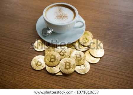 Cryptocurrency golden bitcoin with coffee cup,Choice to make a payment with crypto coin.
