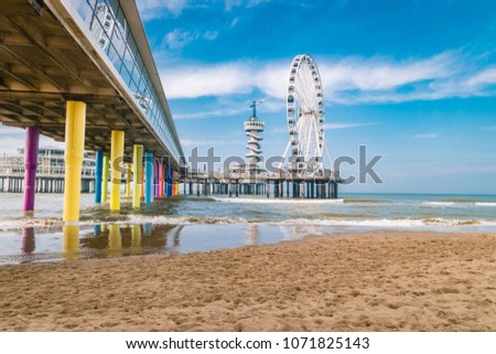 The Ferris Wheel & The Pier at Scheveningen in Netherlands, Sunny spring day at the beach Royalty-Free Stock Photo #1071825143