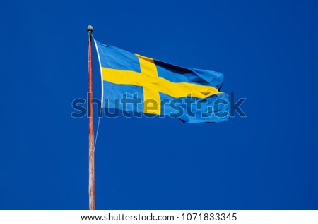 Flag of Sweden against the blue sky, national patriotic background
