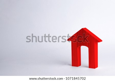 Red wooden house with a large doorway on a white background. The concept of buying and selling real estate, rental housing. Affordable housing, investment and construction. School
