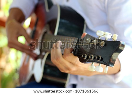 hands play guitar
hands and guitar