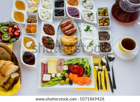 Traditional Turkish Breakfast on the white table with fresh fruits and tea.Top and large view