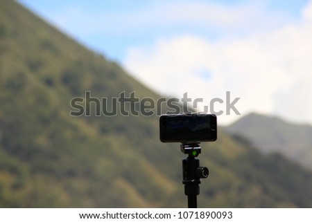 Tripod and camera with bokeh background of Magnificent Nature of Mount Bromo and Mout Batok, Bromo Tengger, East Java, Indonesia.