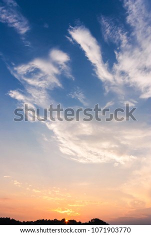 Beautiful blue orange sky with clouds background.
