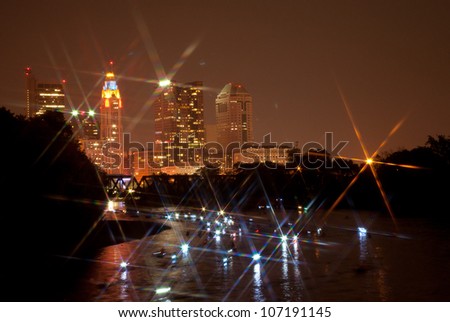 Canoes light up the Scioto river in Columbus Ohio after the fireworks show. A star filter was used for effect.