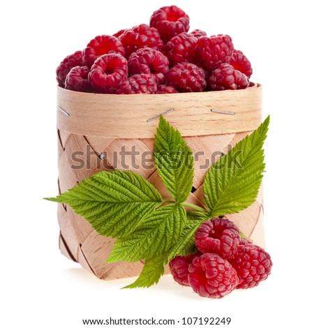 fresh raspberries in the wooden basket close up isolated on white background