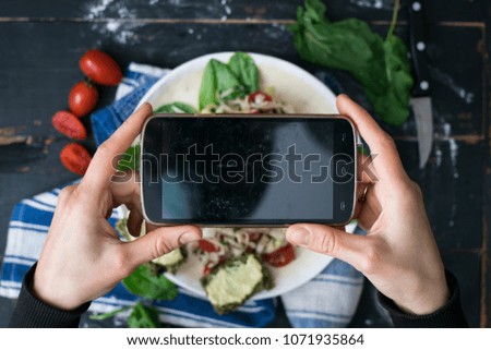 Woman hands make phone photo of fresh cabbage salad plate with vegetables for dinner or lunch. Summer vitamins. Social networks smartphone photography. Empty screen. Raw vegan vegetarian healthy food