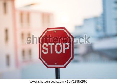Stop sign in front of  old buildings