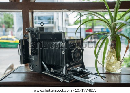 
Antique Camera with Vase