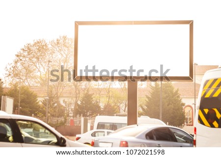 Blank billboard at a frequent highway in downtown of Istanbul. Visual media banner captured at sunset and rush hours with many cars waiting to move.