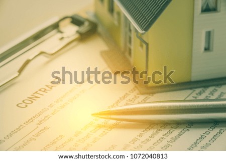 Business legal document, contract / agreement concept : Pen on a business contract, a form on a clipboard. Contract is a voluntary, deliberate and legally binding agreement between two or more parties