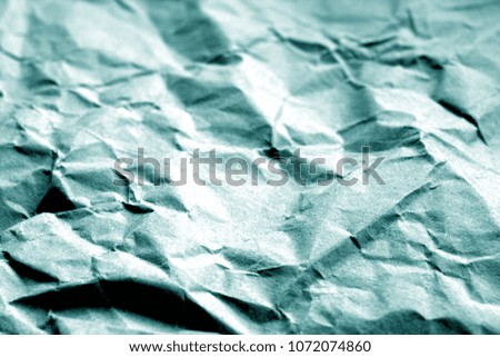 Old paper with wrinckles in cyan color. Abstract background and texture for design.