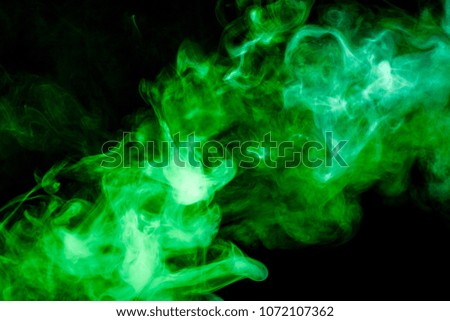 green cloud of smoke of  black isolated background. Background from the smoke of vape