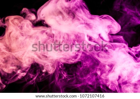 Dense multicolored pink and red smoke  on a black isolated background. Background of smoke vape
