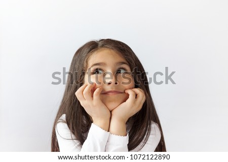 Portrait of cute thoughtful child girl. Dreaming people. Space for text.